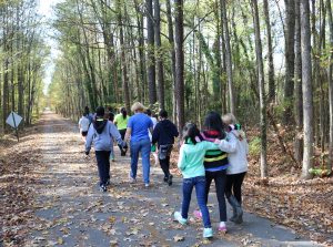 Walking Classroom learning STEM in wooded area
